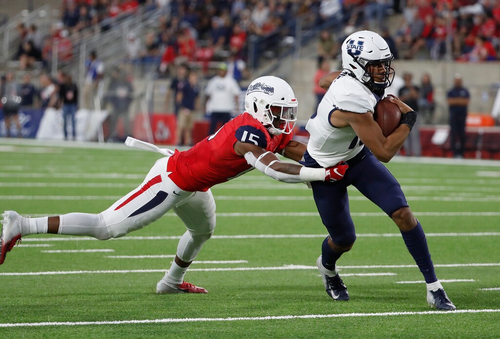 Utah State quaterback Jordan Love tries to avoid Fresno State linebacker Arron Mosby during the first half of an NCAA college football game in Fresno, Calif., Saturday, Nov. 9, 2019. (AP Photo/Gary Kazanjian)