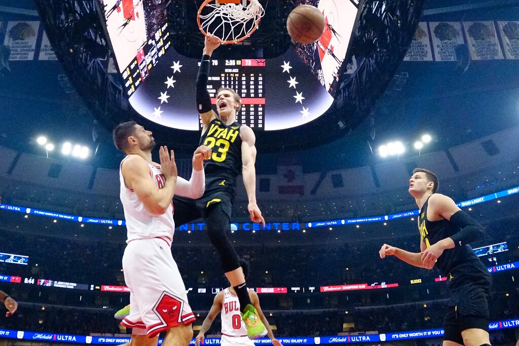 Utah Jazz forward Lauri Markkanen (23) dunks against Chicago Bulls center Nikola Vucevic (9) during the second half of an NBA basketball game Saturday, Jan. 7, 2023, in Chicago. (AP Photo/David Banks)