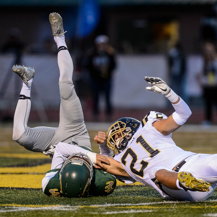 (Trent Nelson | The Salt Lake Tribune) Lone Peak's Thomas Bateman brings down Kearns' Jeremiah Cervantes as Kearns hosts Lone Peak, high school football, Thursday September 14, 2017.