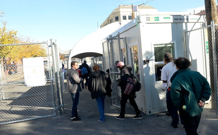 (Al Hartmann | The Salt Lake Tribune)
Starting Friday Oct. 27 homeless check in at booth at right to have their coordinated services card scanned before passing into the "safe space" courtyard outside the Road Home shelter. The area is accessible from the south on Rio Grand Street. The area to the north at 200 South and Rio Grand is fenced and locked.