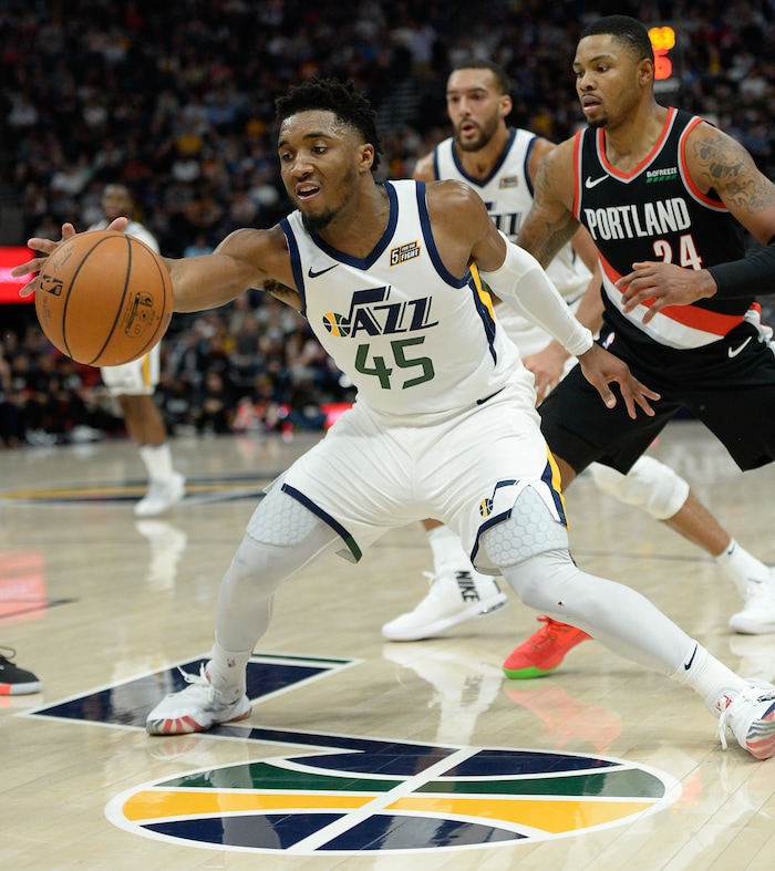(Francisco Kjolseth  |  The Salt Lake Tribune)  Utah Jazz guard Donovan Mitchell (45) reaches out for a ball as the Utah Jazz host the Portland Trailblazers in their NBA basketball game at Vivint Smart Home Arena in Salt Lake City on Wed. Oct. 16, 2019.