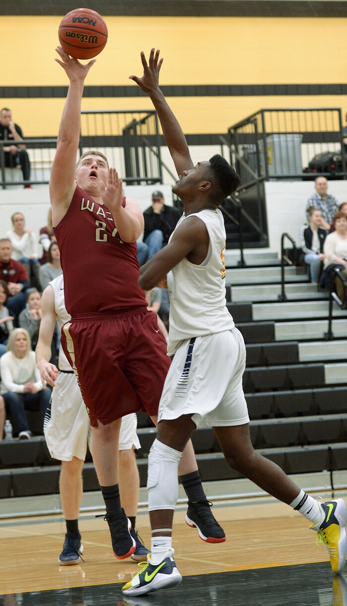(Leah Hogsten  |  The Salt Lake Tribune) Juab's Raiden Gould shoots around Summit's Jalexus Gilson. Juab High School boys' basketball team defeated Summit Academy 61-58 during their 3A State tournament game in Heber  Saturday, Feb. 16, 2018.
