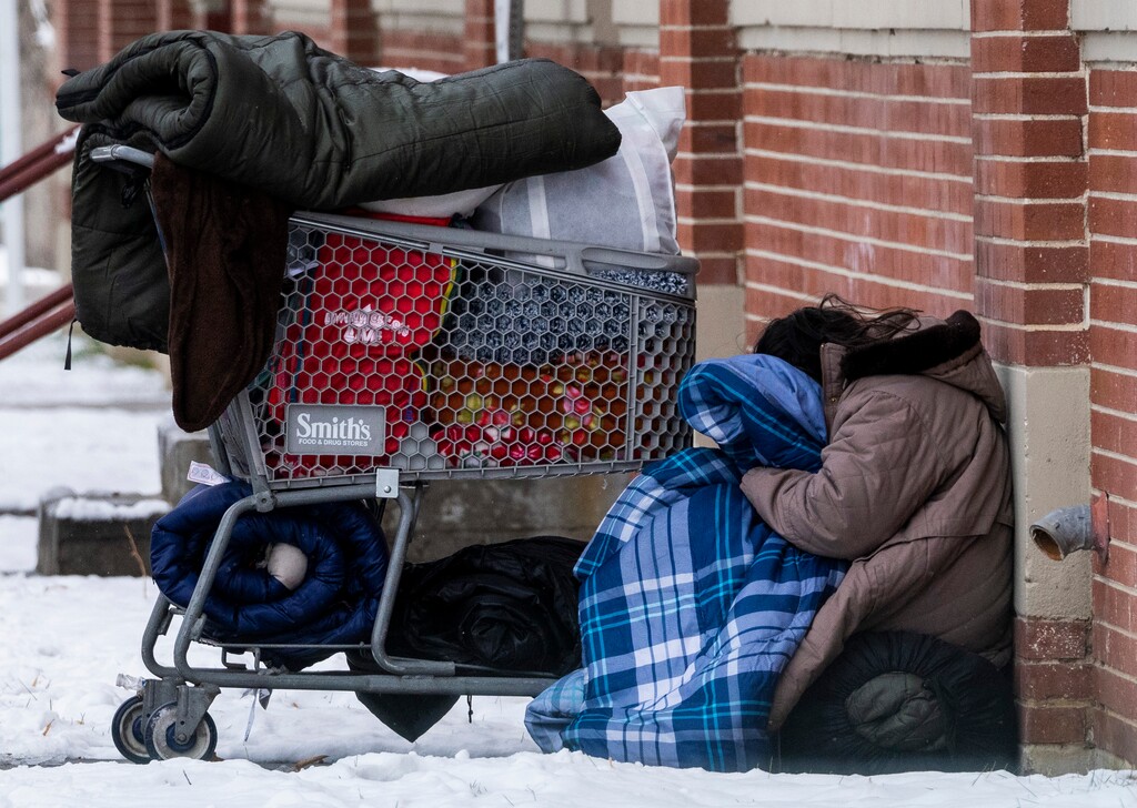 (Rick Egan | The Salt Lake Tribune)  Salt Lake City is not allowing unsheltered people to sleep in tents, so   blanket are used to shelter from the cold, on Tuesday, December 28, 2021.