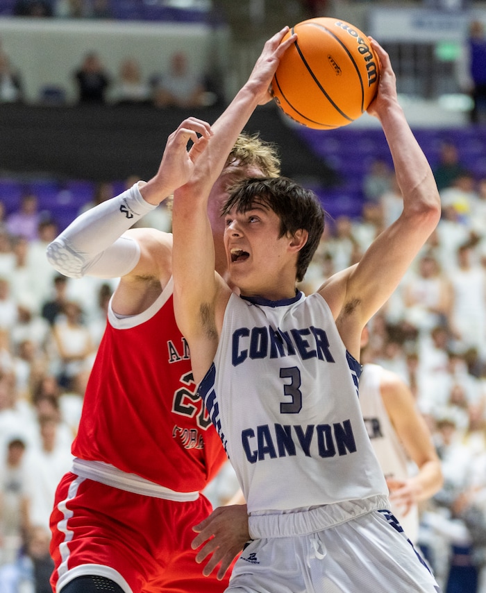 (Rick Egan | The Salt Lake Tribune) Peterson Lunt, Corner Canyon goes to the basket as Ashton Wallace defends for American Fork, in the Boys 6A State Championship at Weber State, on Saturday, March 4, 2023.