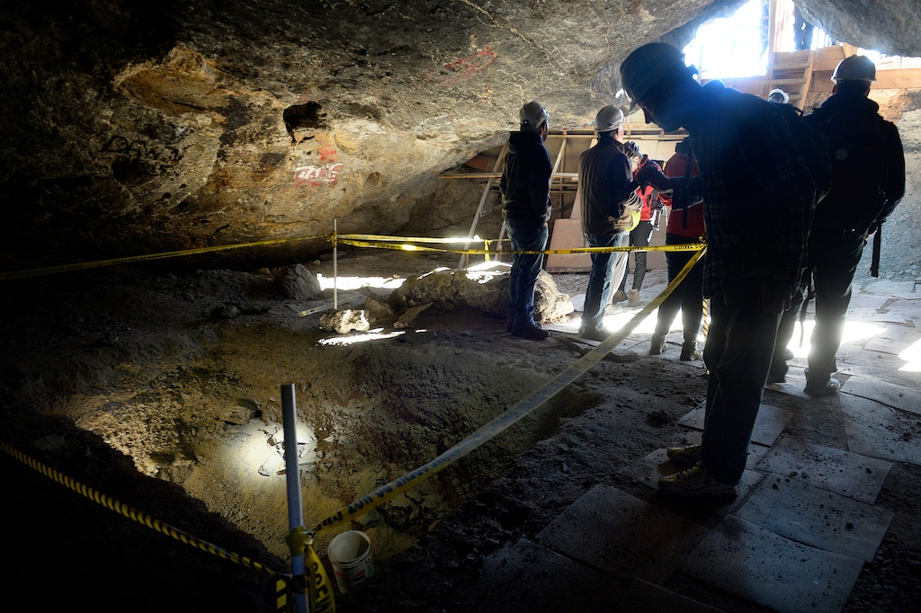 (Scott Sommerdorf   |  Tribune file photo) In this 2015 file photo, hikers peer into an excavated site of Danger Cave near Wendover.