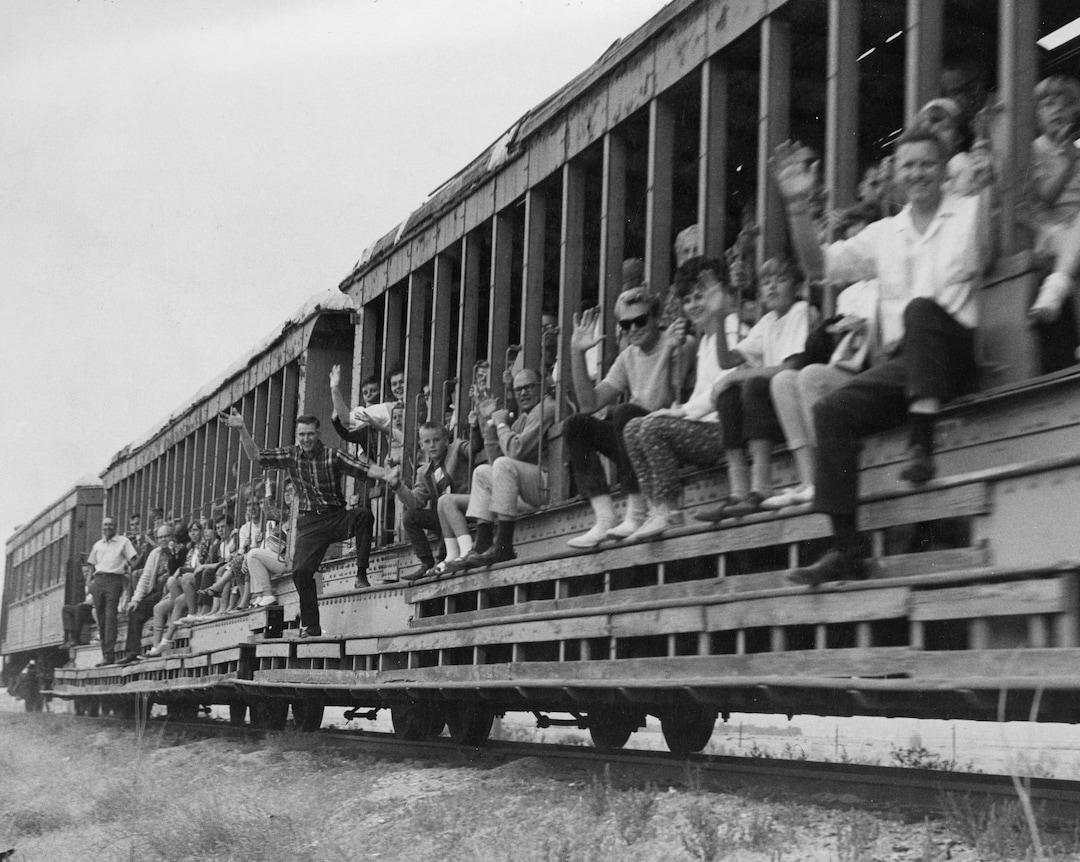 (Utah State Historical Society) Saltair enthusiasts ride the train from Salt Lake City to Saltair in July 1966. The ride and subsequent fundraising efforts that year was an attempt to refurbish the dilapidated resort that had been shuttered for 8 years. The fundraising effort failed and the resort burned to the ground 4 years later after it was set ablaze by an arsonist.
