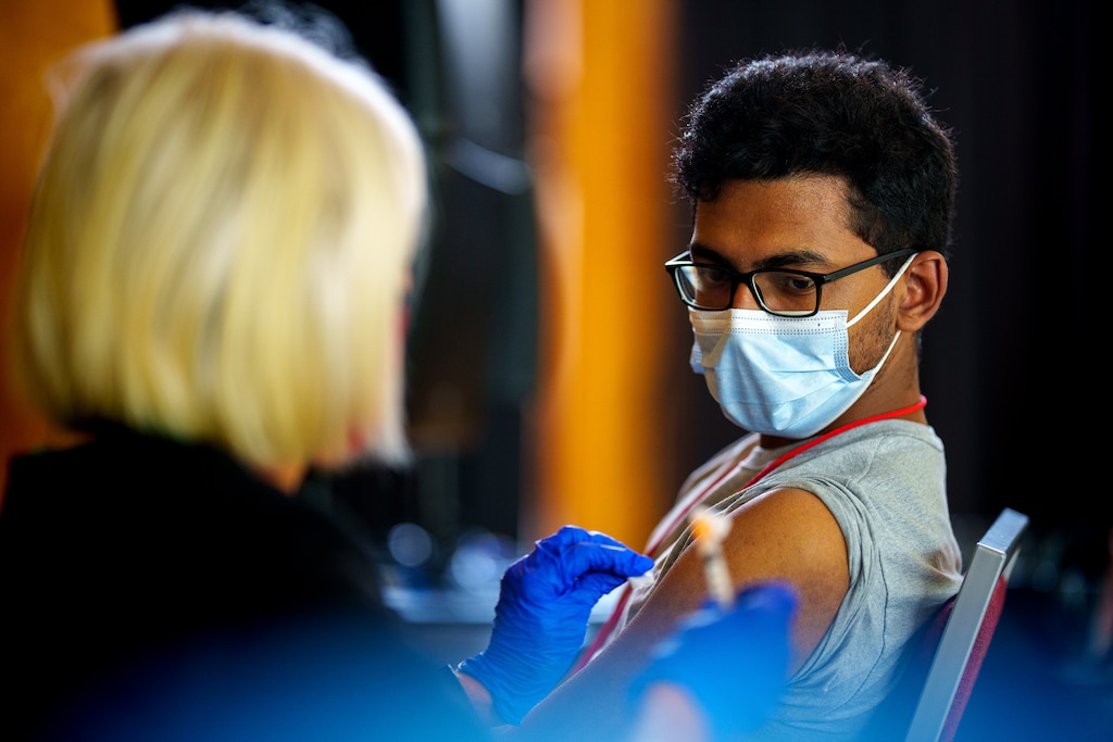(Trent Nelson  |  The Salt Lake Tribune) Nurse Sue Day administers a COVID-19 vaccine to University of Utah student Dev Banerjee in Salt Lake City on Friday, Aug. 20, 2021.