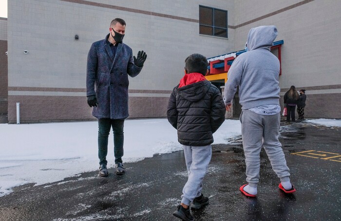 (Leah Hogsten | The Salt Lake Tribune) Escalante Elementary assistant principal Kody Colvin greets his students s they file back to class in Salt Lake City, January, 25, 2021. Salt Lake City School District reopened all of the district's elementary schools to in-person learning on Monday. It is the first time students in kindergarten through sixth grade are back in the classroom for a full day of school since they first closed for the pandemic in March 2020.