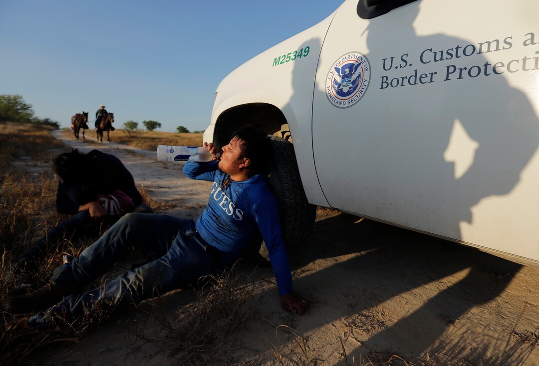 In this Wednesday, Nov. 6, 2019, photo, Border Patrol agents apprehend a man thought to have entered the country illegally, near McAllen, Texas, along the U.S.-Mexico border. In the Rio Grande Valley, the southernmost point of Texas and historically the busiest section for border crossings, the U.S. Border Patrol is apprehending around 300 people daily. That’s down from as many as 2,000 people a day in May.  (AP Photo/Eric Gay)