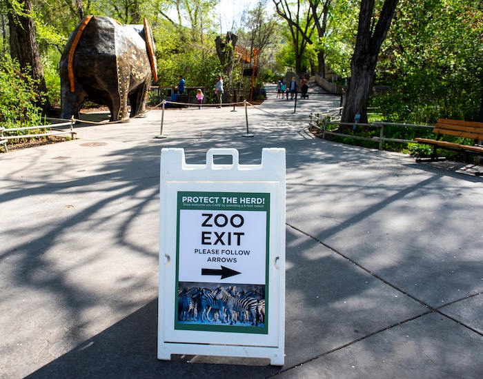 (Rick Egan  |  The Salt Lake Tribune)  A sign directs traffic, to help with social distancing, at the Hogle Zoo re-opend,Saturday May 2, 2020