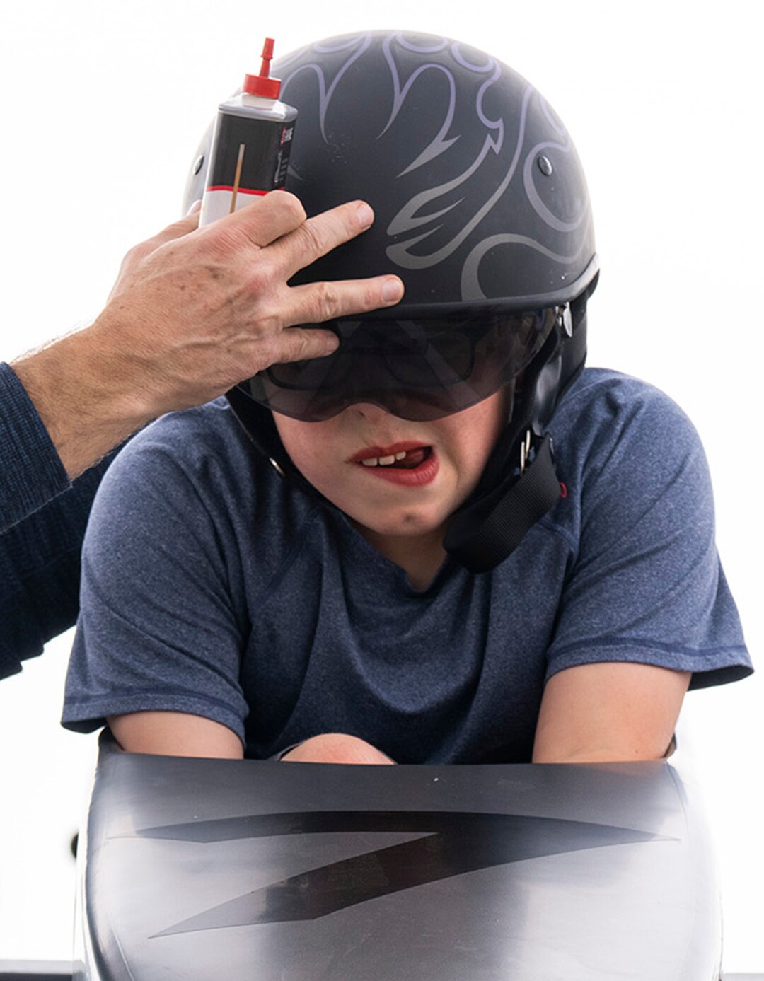 (Rick Egan | The Salt Lake Tribune) Ben Swenson gives Lanson Swenson a helmet adjustment as he races Mr Holographic! in the Daybreak Soap Box Derby, on Saturday, April 24, 2021.