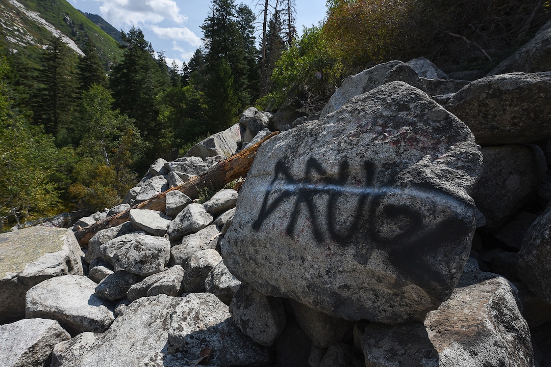(Francisco Kjolseth  |  The Salt Lake Tribune)  Graffiti has proliferated in lower Little Cottonwood Canyon, where vandals, often wielding cans of fluorescent-colored spray paint, have covered granite faces, trees and structures. The vandalism is particularly apparent along the Temple Quarry Trail and the creek at the Moon Rock swimming hole and former pavilion site. Volunteers using donated equipment and solvents spend thousands of hours removing the paint from the rocks only to see graffiti return to the same faces or on rock nearby.