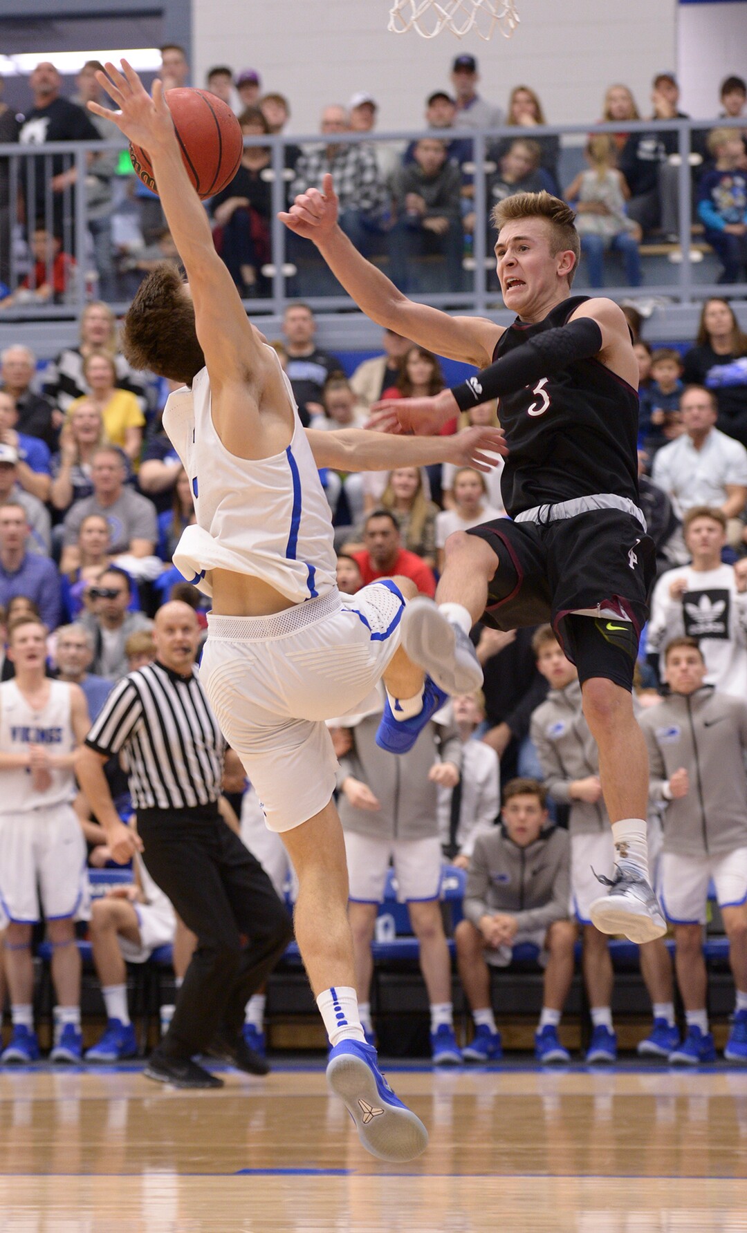 (Leah Hogsten  |  The Salt Lake Tribune) Lone Peak's Steven Ashworth swats the ball away from Pleasant Grove Casey Brown.  Lone Peak High School boys' basketball team defeated Pleasant Grove High School 65-61 during their game Friday, January 26, 2018 in Pleasant Grove. 