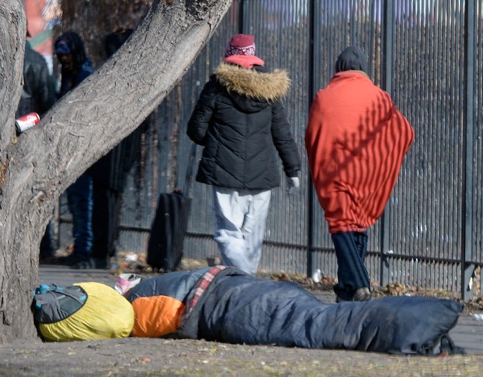 Al Hartmann  |  The Salt Lake Tribune
Bundled up homeless people walk along 500 West near the Road Home shelter past a person on the sidewalk in a sleeping bag on a cold morning Wedneday Dec. 7.  
The Collective Impact steering committee met today to review a survey of homeless people in the Rio Grande area to determine if more overflow shelter space is needed.

