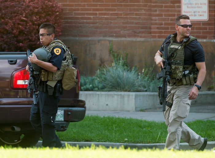 (Rick Egan  |  The Salt Lake Tribune)   Police stand by as swat teams search buildings on Rio Grande Street for a suspect that fired shots at a police officer,  Wednesday, Sept. 5, 2018.


