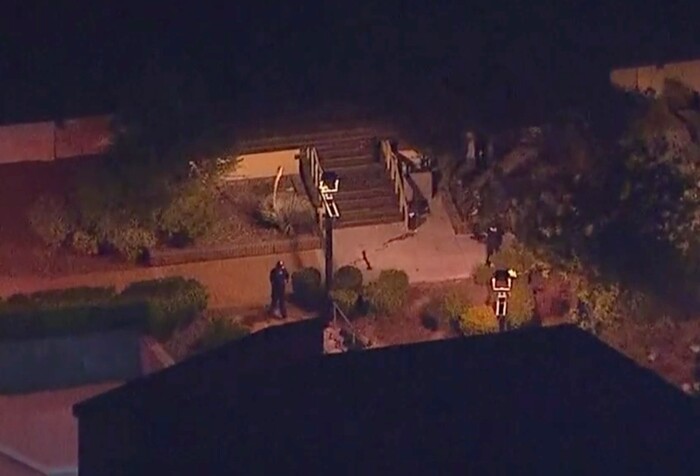 In this image made from aerial video, police move through the vicinity of a shooting in Thousand Oaks, California, early Thursday, Nov. 8, 2018. Authorities say there were multiple injuries _ including one officer _ after a man opened fire in Southern California bar late Wednesday. (KABC via AP)