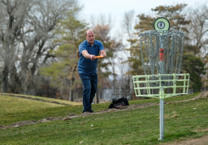 (Francisco Kjolseth  |  The Salt Lake Tribune)  Long time disc golfer Nathan Ottesen of Orem tries out the Roots Disc Golf Course in the Rose Park neighborhood, site of one of the original disc golf courses in Utah before becoming a ball golf course for nearly 20 years. PGA Tour golfer Tony Finau grew up playing the Jordan River Par-3 course that has been converted back to a disc golf venue.