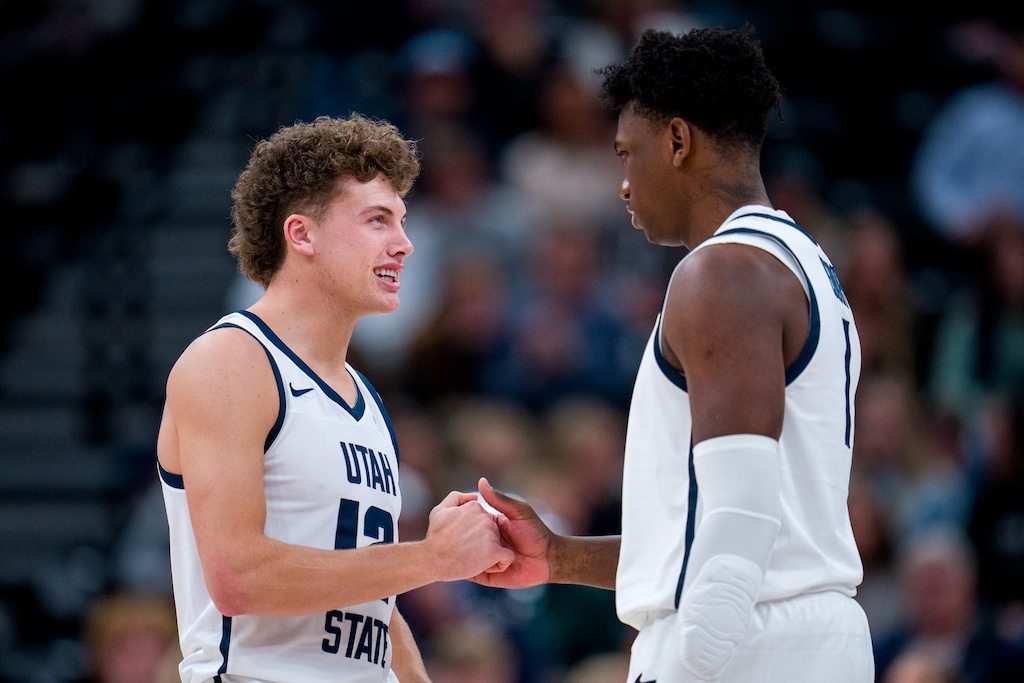 (Trent Nelson  |  The Salt Lake Tribune) Utah State Aggies guard Mason Falslev (12) and Utah State Aggies forward Great Osobor (1) as Utah State faces San Francisco, NCAA basketball in Salt Lake City on Saturday, Dec. 16, 2023.