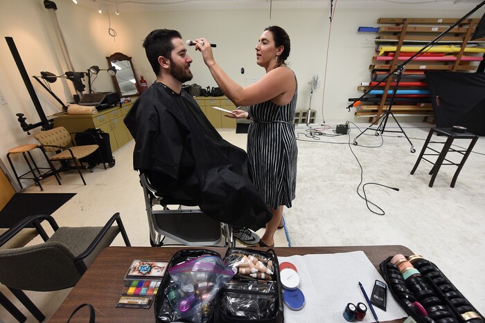 (Francisco Kjolseth | The Salt Lake Tribune) Makeup artist Kristen Packard works her magic on Brad Klekas of South Jordan, a BYU and Utah fan alike as he's willing to show his mutual admiration of both teams by stepping into the Tribune studio to get both colors in anticipation of the upcoming match up between the two rival teams on Saturday.