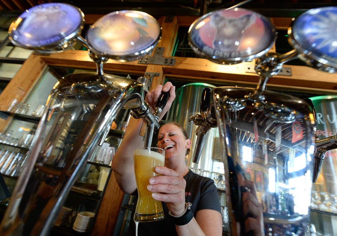 (Francisco Kjolseth  |  The Salt Lake Tribune)  Jessica Means of Squatters in Salt Lake City pours a glass of the Apricot Hefeweizen on draft that is now 5% alcohol by volume on Friday, Nov. 1, 2019.