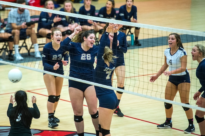 (Chris Detrick | The Salt Lake Tribune) Skyline's Anna Pingree (7) and Skyline's Cameron Mooney (26) celebrate after blocking West's Sarona Snuka (3) during the volleyball match at West High School Tuesday, October 3, 2017.