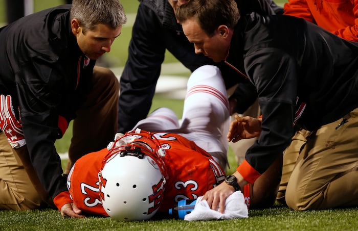 Utah running back Armand Shyne (23) is look at by trainers after being hurt during the second half of an NCAA college football game against Arizona, Saturday, Oct. 8, 2016, in Salt Lake City. (AP Photo/George Frey)

