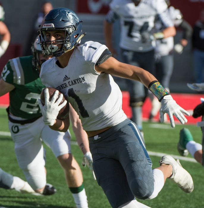 (Rick Egan  |  The Salt Lake Tribune)    John Mitchell (1) runs the ball for Corner Canyon, in 5A football semifinal action between Olympus and Corner Canyon at Rice-Eccles Stadium, Thursday, Nov. 8, 2018.