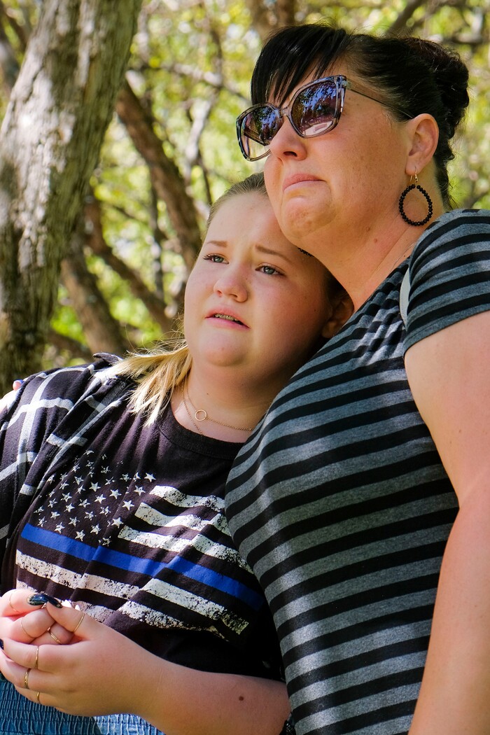 (Leah Hogsten | The Salt Lake Tribune) Emma Clawson and her mother Glenda weep as Heidi Knickerbocker (not pictured) sings a song about an officer who dies in the line of duty at Back the Blue rally in support of law enforcement, Saturday, August 15, 2020 at Washington Square. There are two law enforcement officers in the Clawson family.