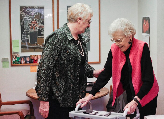 This photo taken Jan. 5, 2018, shows Marian Christensen walking past Felicity Varkevisser in Christensen's kitchen in Provo, Utah. (Evan Cobb/The Daily Herald via AP)