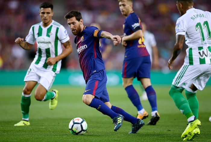 FC Barcelona's Lionel Messi, second left, in action during the Spanish La Liga soccer match between FC Barcelona and Betis at the Camp Nou stadium in Barcelona, Spain, Sunday, Aug. 20, 2017. (AP Photo/Manu Fernandez)