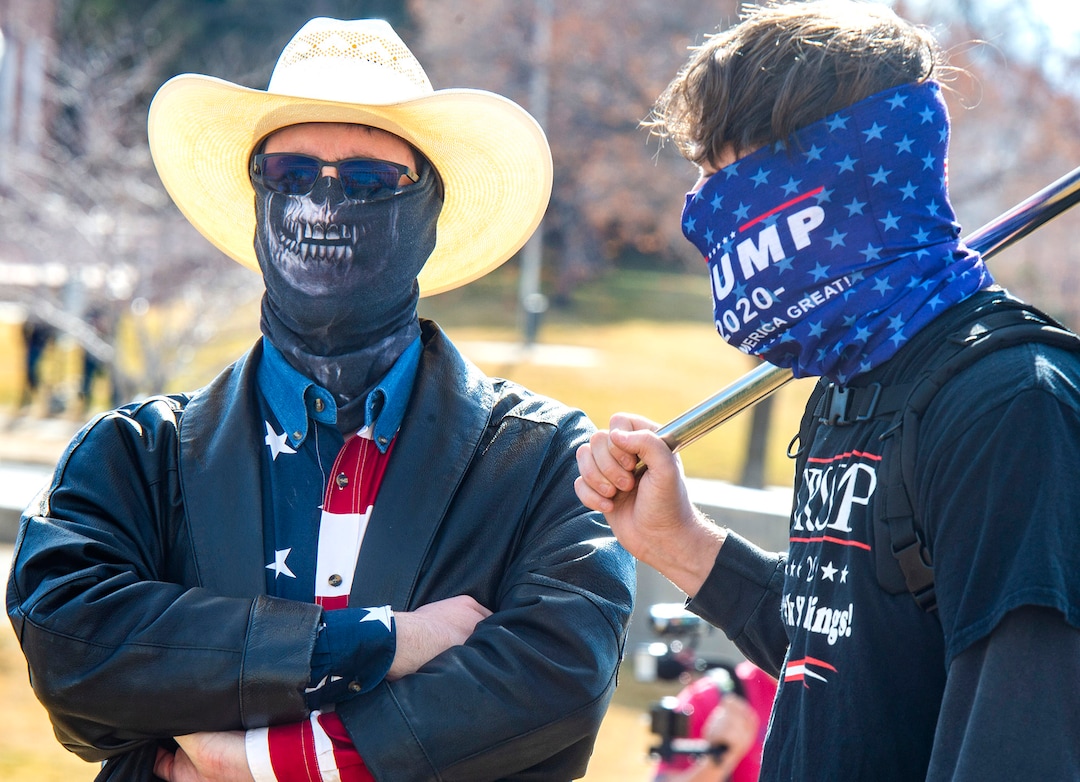 (Rick Egan | The Salt Lake Tribune)  Two of a handful of Trump supporters, stand on the lawn at the state Capitol where police and the National Guard were out in force, on Sunday, Jan. 17, 2021.