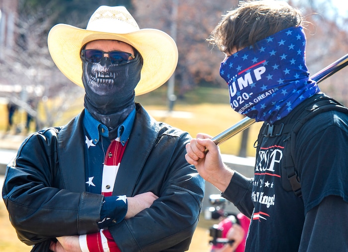 (Rick Egan | The Salt Lake Tribune)  Two of a handful of Trump supporters, stand on the lawn at the state Capitol where police and the National Guard were out in force, on Sunday, Jan. 17, 2021.