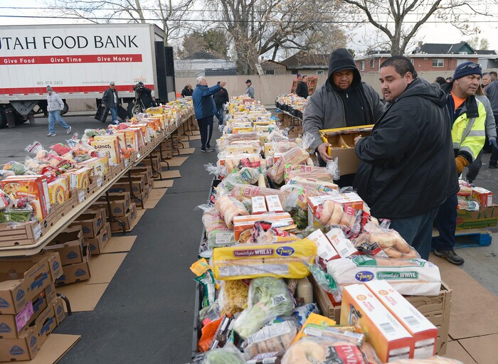 (Al Hartmann | The Salt Lake Tribune)
Volunteers of the Utah Food Bank pack food boxes in the parking lot of the LDS Church at 1860 S. 300 E. in Salt Lake City Friday April 13. It's one of 18 locations the bank operates to get food out to the food insecure. An army of volunteers make the distrbution system work. Walmart, Feeding America and Utah Food Bank are teaming up during the month of April to fight hunger through an online and in-store donation campaign.