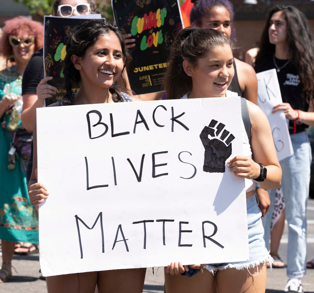(Rick Egan | The Salt Lake Tribune) Maria Agarwal and Chloe Coleman-Houghton and march down 300 South in Salt Lake City, during the Juneteenth celebration, on  Saturday, June 19, 2021.