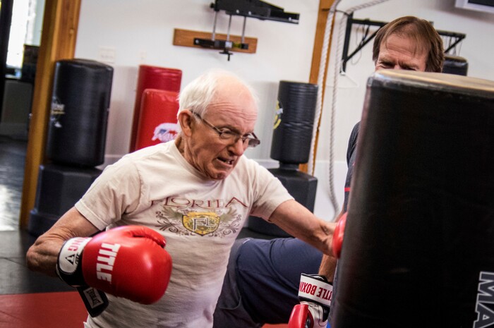 In this June 28, 2017 photo, Jim Erickson, 72, takes part in Rock Steady Boxing, a nationwide program to help people with Parkinson's disease stay active and healthy in Helena, Mont. Rock Steady holds classes three times per week at Frederick's ATA Martial Arts gym in Helena.  (Matt Neuman/Independent Record via AP)