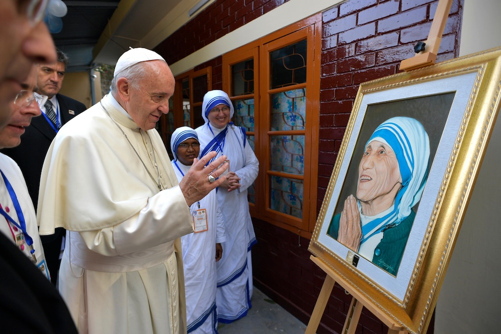 Pope Francis blesses an image of Mother Teresa during a visit at the Missionaries of Charity House in the Dhaka's Tejgaon neighborhood, Bangladesh, Saturday, Dec. 2, 2017. (L'Osservatore Romano/Pool Photo Via AP)