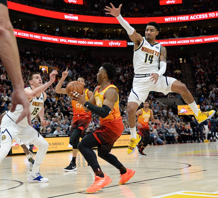 (Francisco Kjolseth  |  The Salt Lake Tribune)  Utah Jazz guard Donovan Mitchell (45) looks for an open teammate as Denver Nuggets guard Gary Harris (14) sails by as the Utah Jazz host the Denver Nuggets in their NBA game at Vivint Smart Home Arena Tuesday, April 9, 2019, in Salt Lake City.