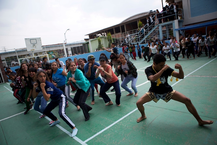In this Aug. 25, 2017 photo, Muay Thai practitioners lead mostly female students at a nursing school in a self-defense workshop in Nezahualcoyotl, Mexico state. "We want to help them prepare in case they have to defend themselves," martial arts instructor Cristofer Fuentes said. (AP Photo/Rebecca Blackwell)