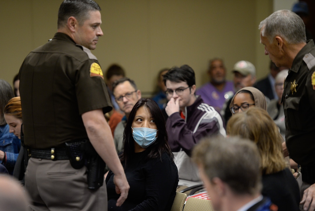 (Francisco Kjolseth  |  The Salt Lake Tribune)  Utah Highway Patrol troopers remove a woman blowing a whistle through a surgical mask as the Utah Inland Port Authority meets for the first time since its June meeting was disrupted by protestors at the Utah Capitol on Thursday, Oct. 17, 2019.