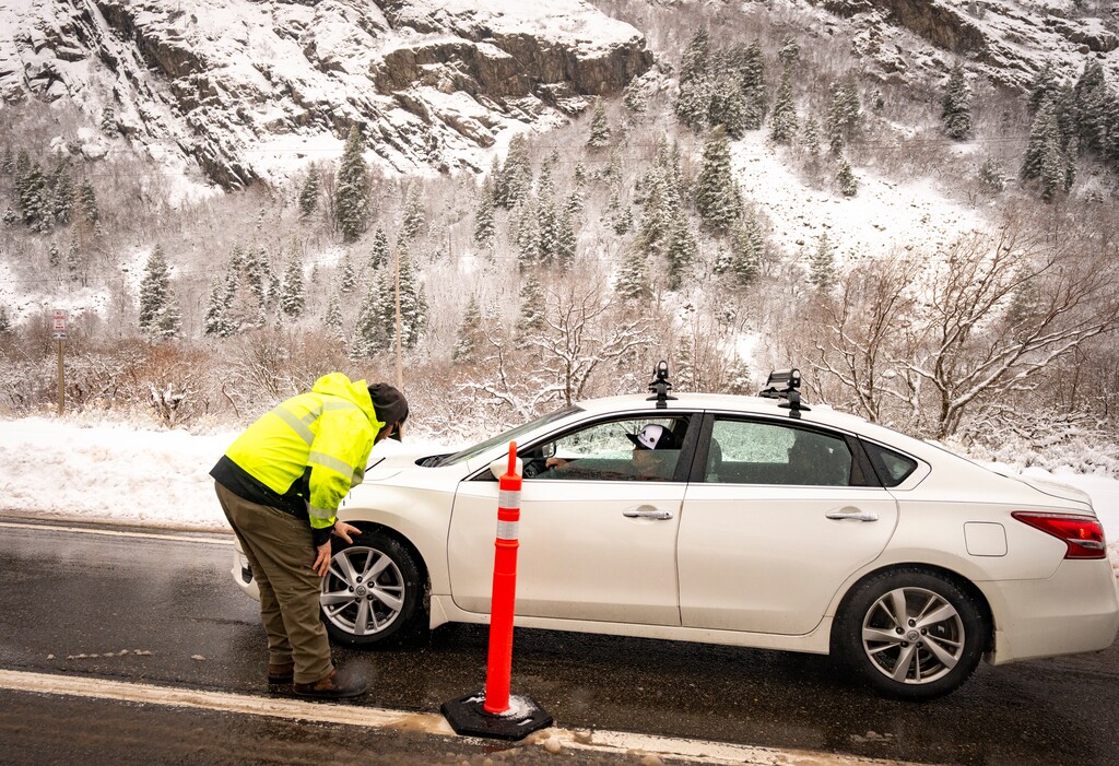 (Rick Egan | The Salt Lake Tribune) Jake Brown with the Utah Department of Transportation checks the tread of a car's tires at the entrance to Little Cottonwood Canyon on Friday, Mar 7, 2025.