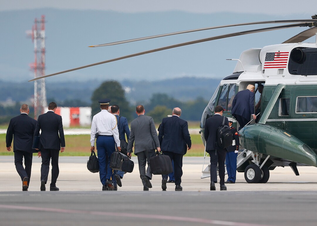 President Donald Trump, right, boards Marine One helicopter, followed by members of his staff at Hagerstown Regional Airport in Hagerstown, Md., Friday, Aug. 18, 2017, en route to nearby Camp David, for a meeting with his national security team to discuss strategy for South Asia, including India, Pakistan and the way forward in Afghanistan. (AP Photo/Pablo Martinez Monsivais)