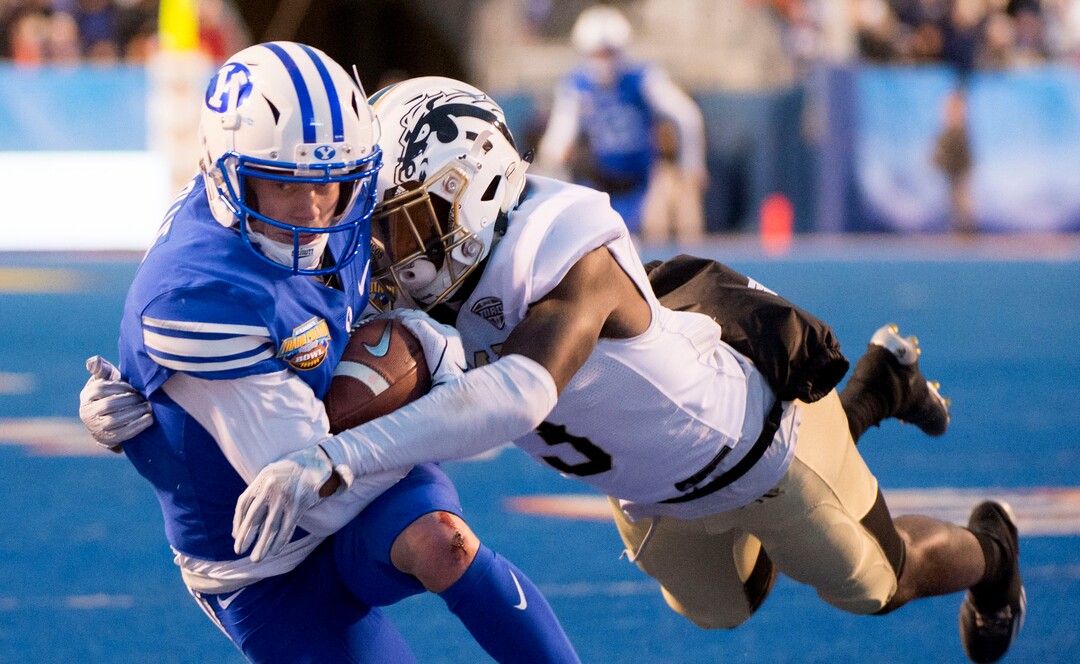 (Jeremy Harmon  |  The Salt Lake Tribune) Brigham Young Cougars wide receiver Dylan Collie (3) catches the ball under pressure from Western Michigan Broncos wide receiver Anton Curtis (3) as BYU faces the Western Michigan Broncos in the Famous Idaho Potato Bowl in Boise, Idaho, on Friday, Dec. 21, 2018.