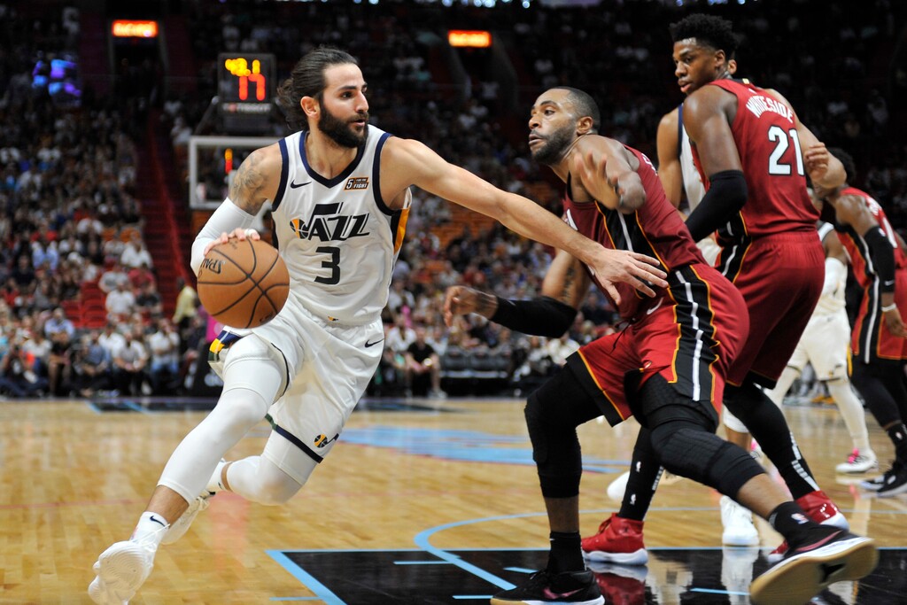 Utah Jazz guard Ricky Rubio (3) dribbles to the basket past the Miami Heat defense during the first half of an NBA basketball game, Sunday, Dec 2, 2018, in Miami. (AP Photo/Gaston De Cardenas)