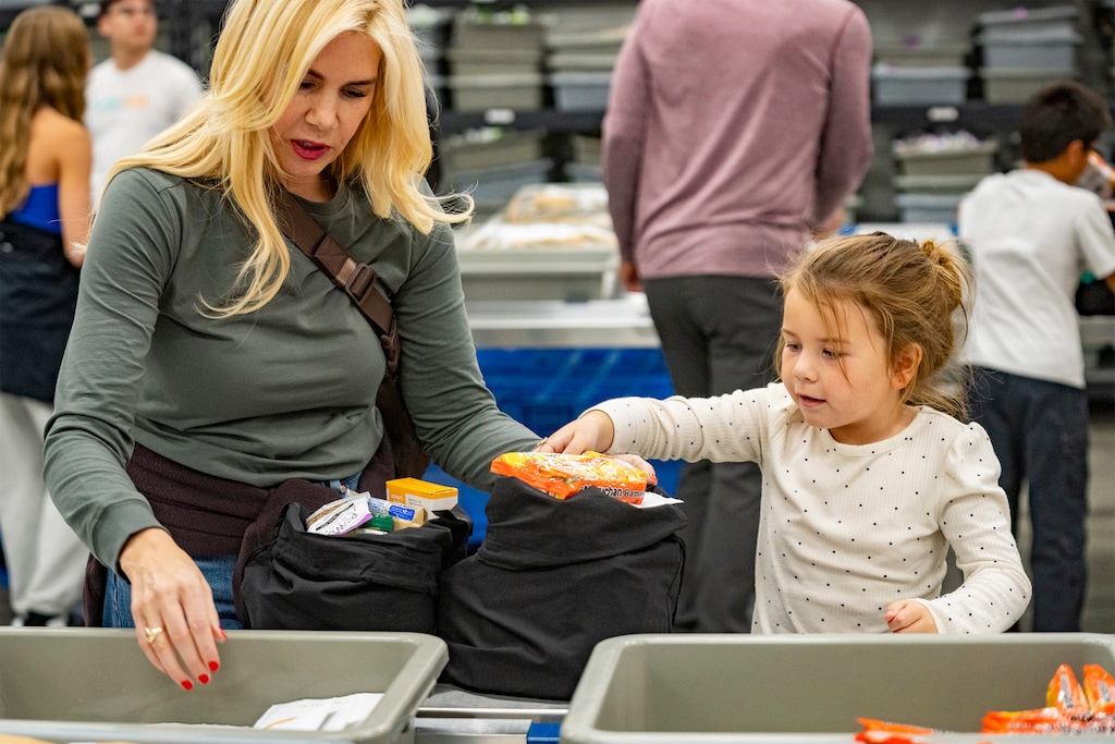 (Rick Egan | The Salt Lake Tribune) Samantha Whitney helps her mother, Melissa Caress, pack food bags at the USANA Foundation to distribute to people who haven't received SNAP benefits on Wednesday, Nov. 5, 2025.