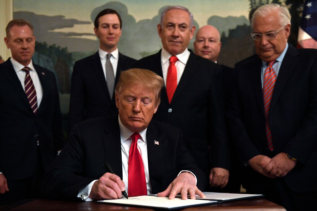 President Donald Trump, front, signs a proclamation in the Diplomatic Reception Room at the White House in Washington, Monday, March 25, 2019. Trump signed an official proclamation formally recognizing Israel's sovereignty over the Golan Heights. Others attending are, from left, Acting Defense Secretary Patrick Shanahan, White House adviser Jared Kushner, Israeli Prime Minister Benjamin Netanyahu, U.S. special envoy Jason Greenblatt, and U.S. Ambassador to Israel David Friedman. (AP Photo/Susan Walsh)