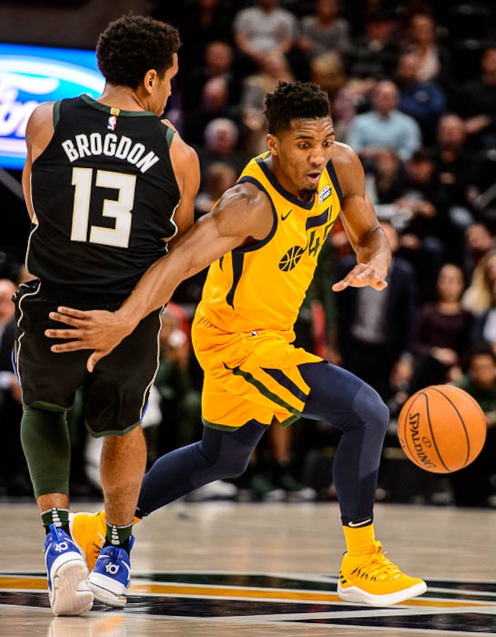 (Trent Nelson | The Salt Lake Tribune)  Utah Jazz guard Donovan Mitchell (45) drives around Milwaukee Bucks guard Malcolm Brogdon (13) as the Utah Jazz host the Milwaukee Bucks, NBA basketball in Salt Lake City Saturday November 25, 2017.