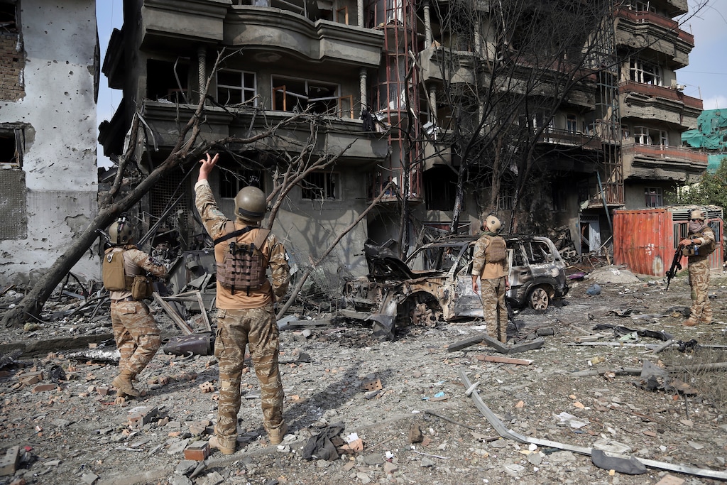 (Rahmat Gul | AP file photo) Afghan security forces inspect the aftermath an attack in Kabul, Afghanistan on July 29, 2019.