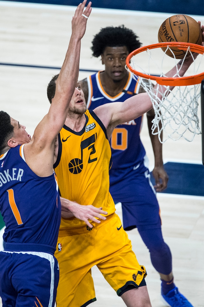 (Chris Detrick  |  The Salt Lake Tribune)  Utah Jazz forward Joe Ingles (2) shoots past Phoenix Suns guard Devin Booker (1) during the game at Vivint Smart Home Arena Thursday, March 15, 2018. 