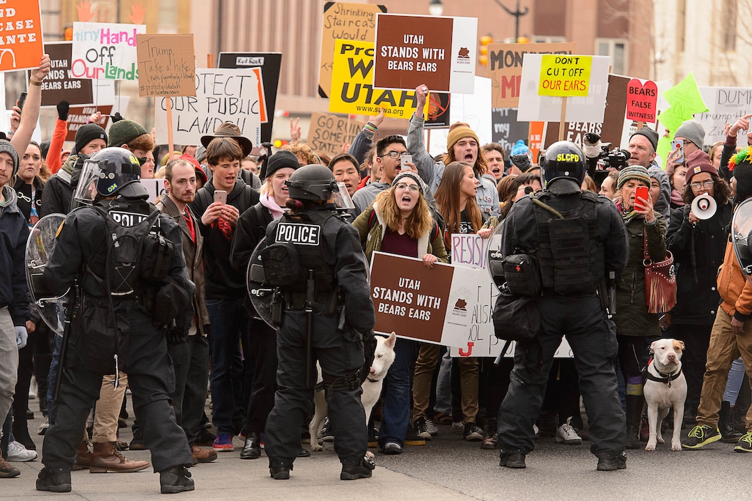 (Trent Nelson | The Salt Lake Tribune)  Police and protesters downtown after a rally against a visit by President Donald Trump, Monday December 4, 2017.