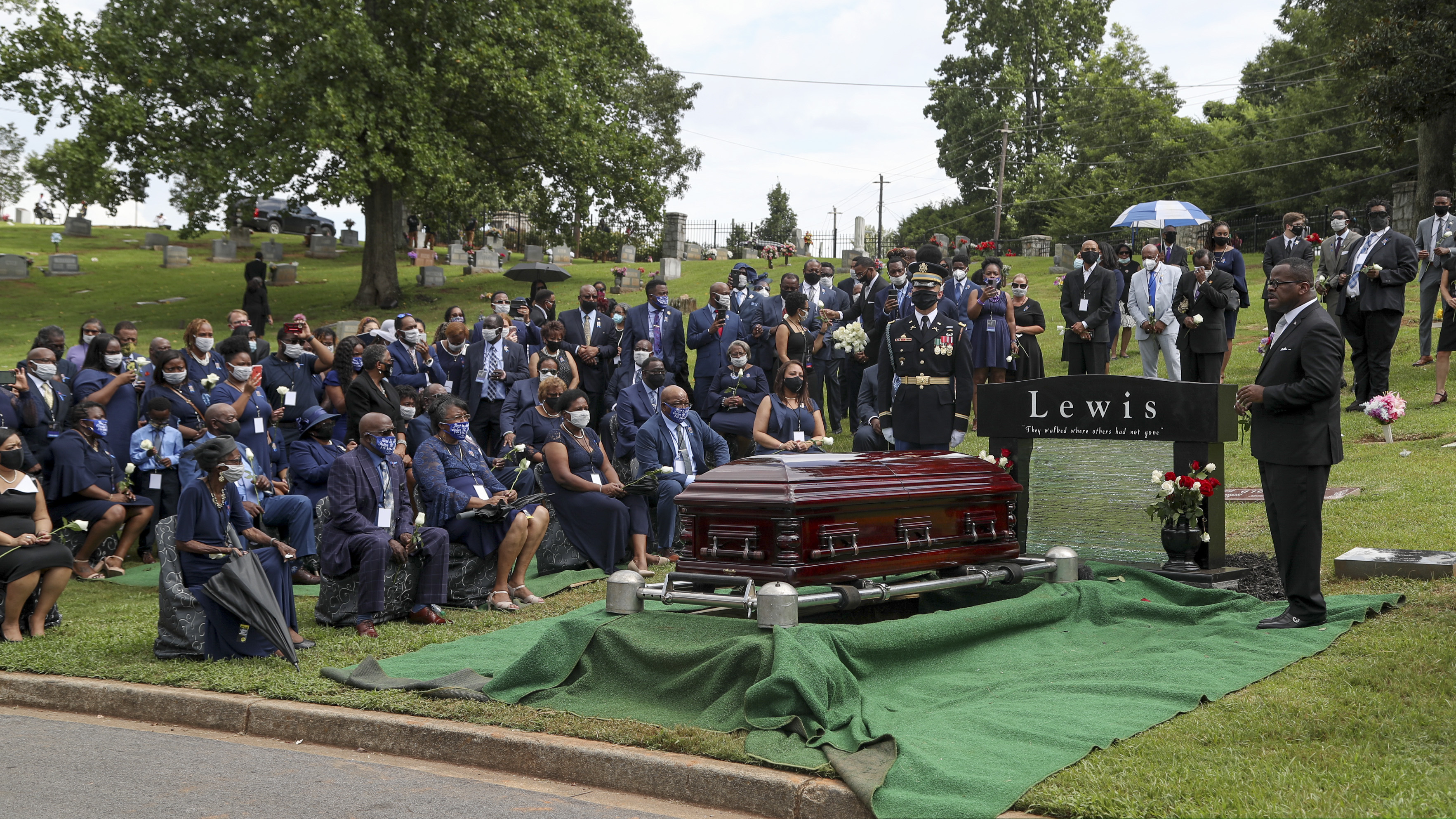 People attend the burial service for Rep. John Lewis at South-View Cemetery in Atlanta Thursday, July 30, 2020. (Alyssa Pointer/Atlanta Journal-Constitution via AP, Pool)